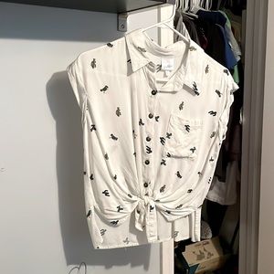 White shirt sleeve, button up top, with tie front.